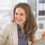 Portrait of happy business woman sitting in office
